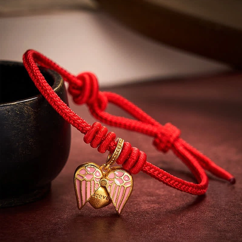 Close-up of red braided cord and double-sided enamel heart pendant with adjustable knots