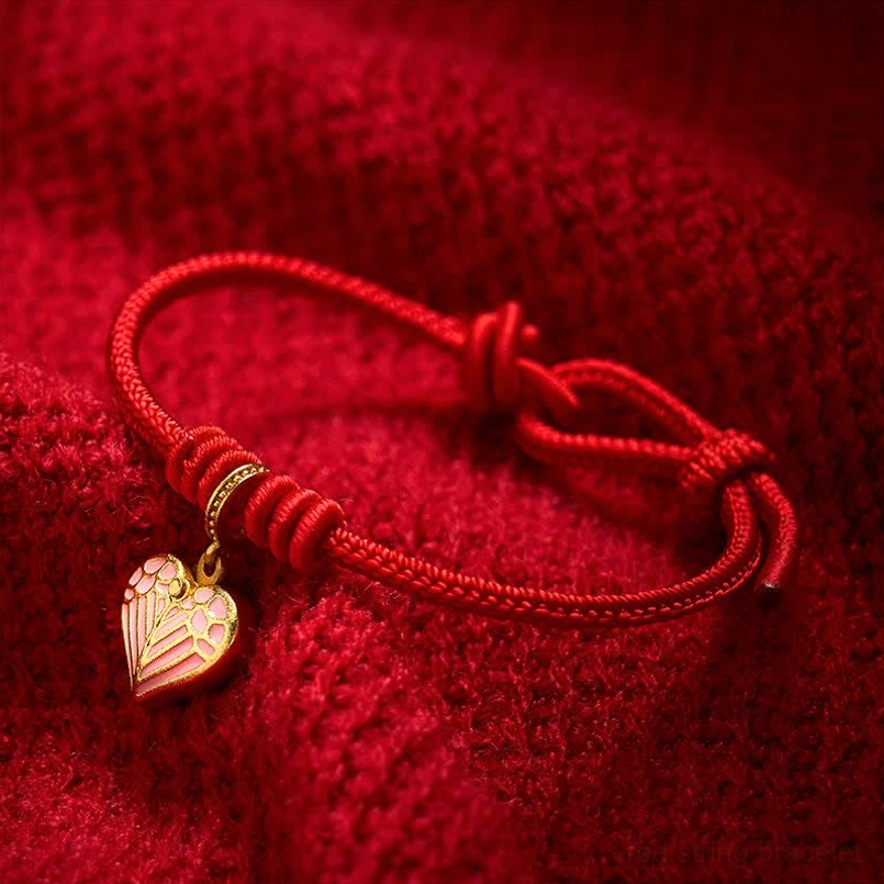 Red string love bracelet with protective heart charm perfect for gifting or daily wear