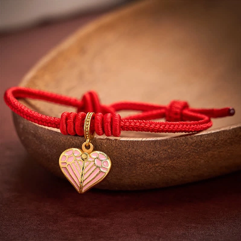 Red string protection bracelet with heart pendant symbolizing love and luck