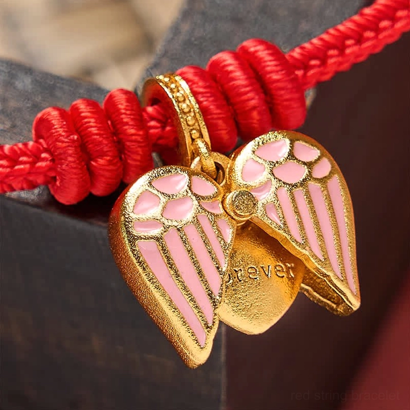 Traditional red string bracelet with modern enamel heart charm design