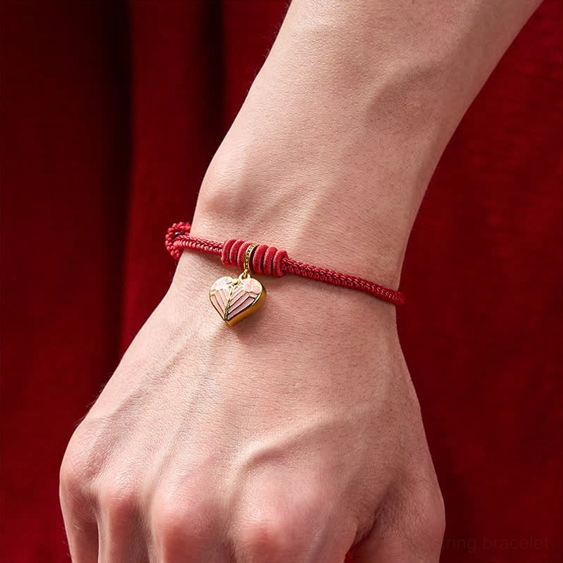Red string heart bracelet worn on wrist showing slim fit and compact cord design