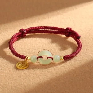 Red string Hetian jade peace buckle 925 silver Fu charm bracelet flat lay view