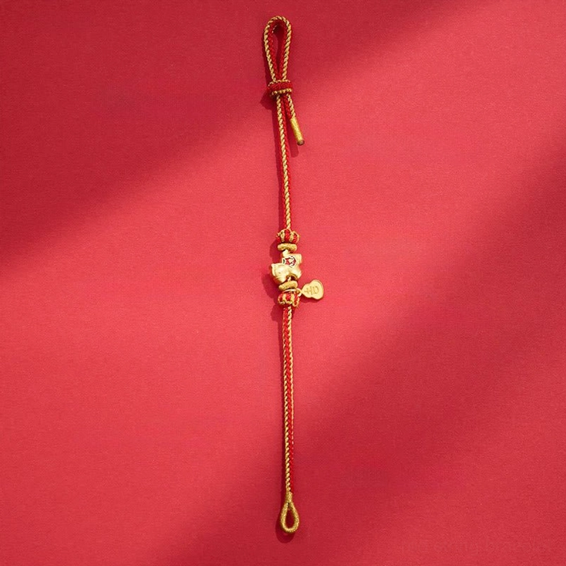 Adjustable red string bracelet with pull-tab knot design featuring horse and gold charm details