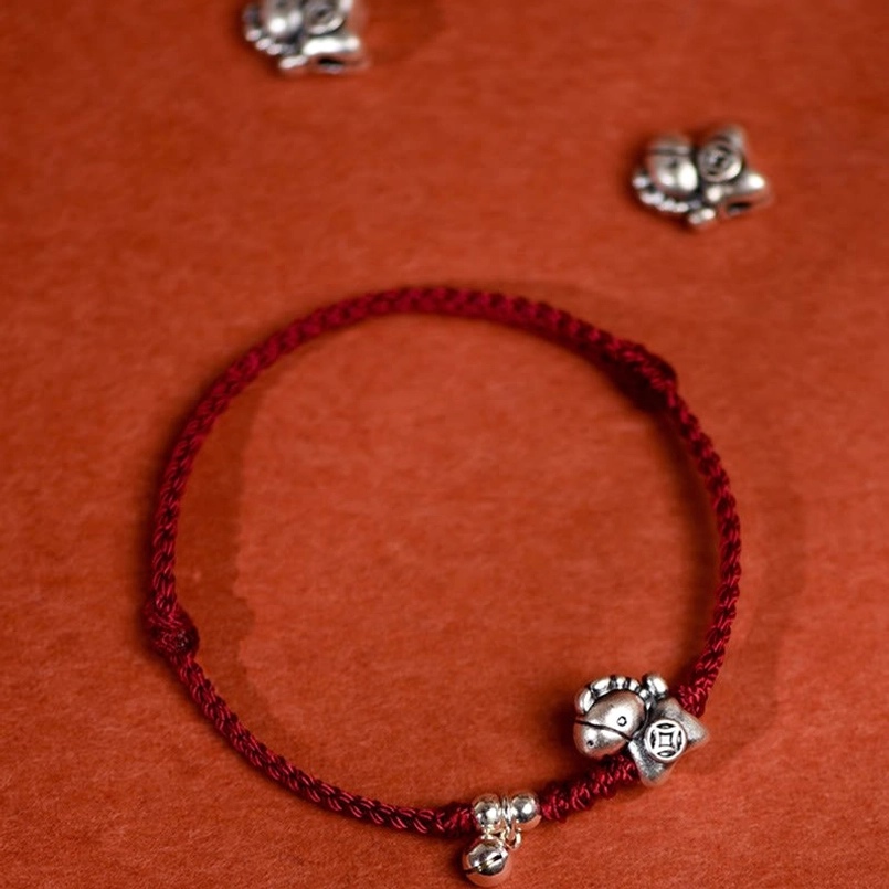 Red string bracelet with Year of the Horse silver horse charm and bell accent detail