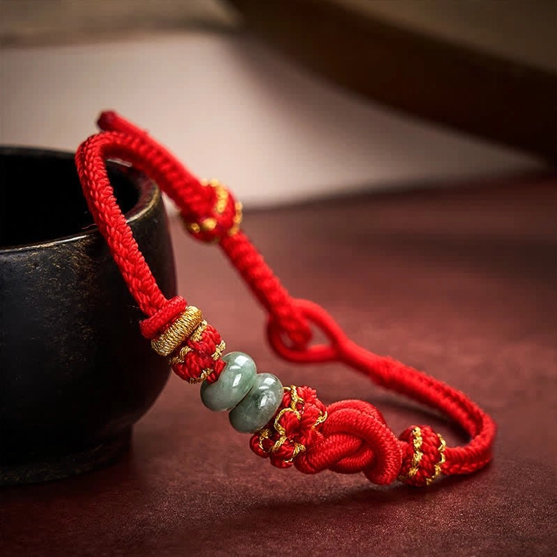 Adjustable red knot jade bracelet with sliding closure close-up