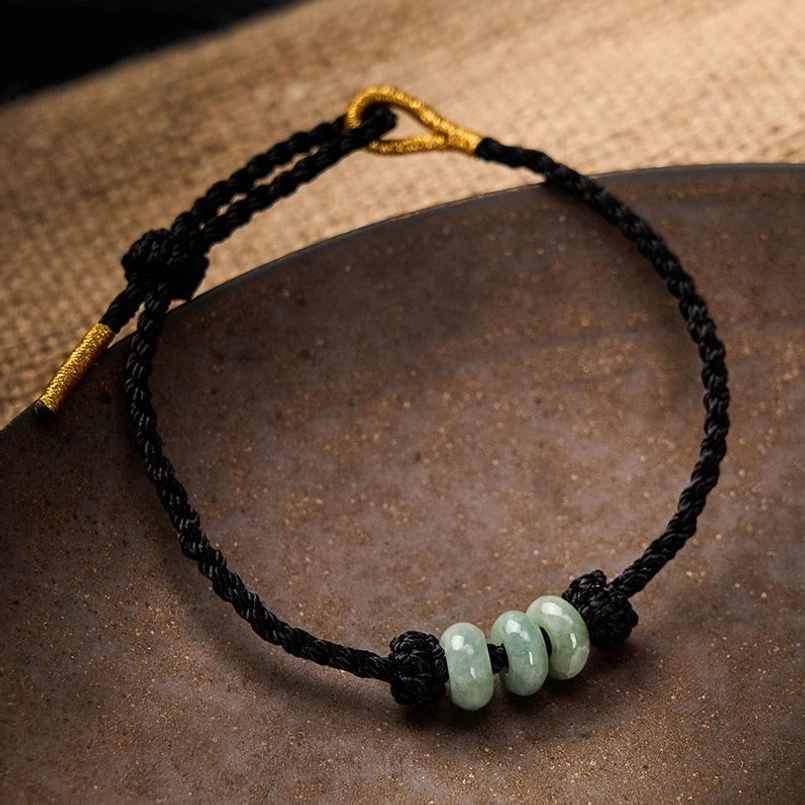 Red string jade bracelet showing 3mm bead size and braided cord construction