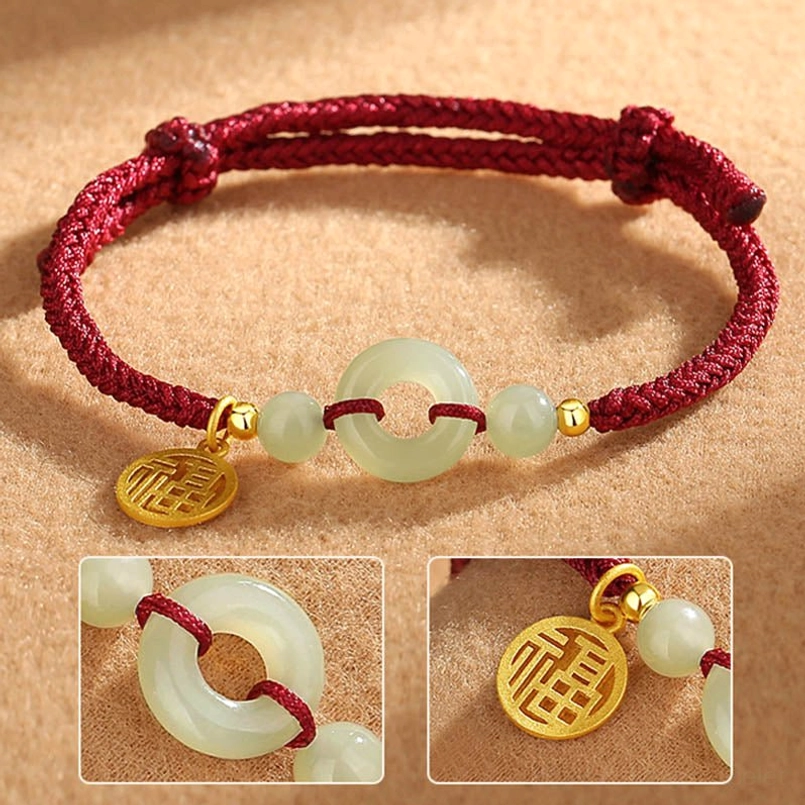 Close up details of red cord Hetian jade peace buckle and Fu charm bracelet