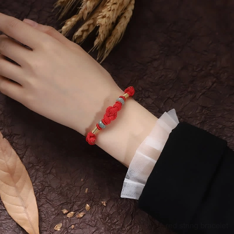 Red string jade fortune knot bracelet - premium natural materials close-up