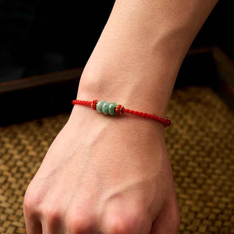Red string jade bracelet side profile view showing bead arrangement pattern