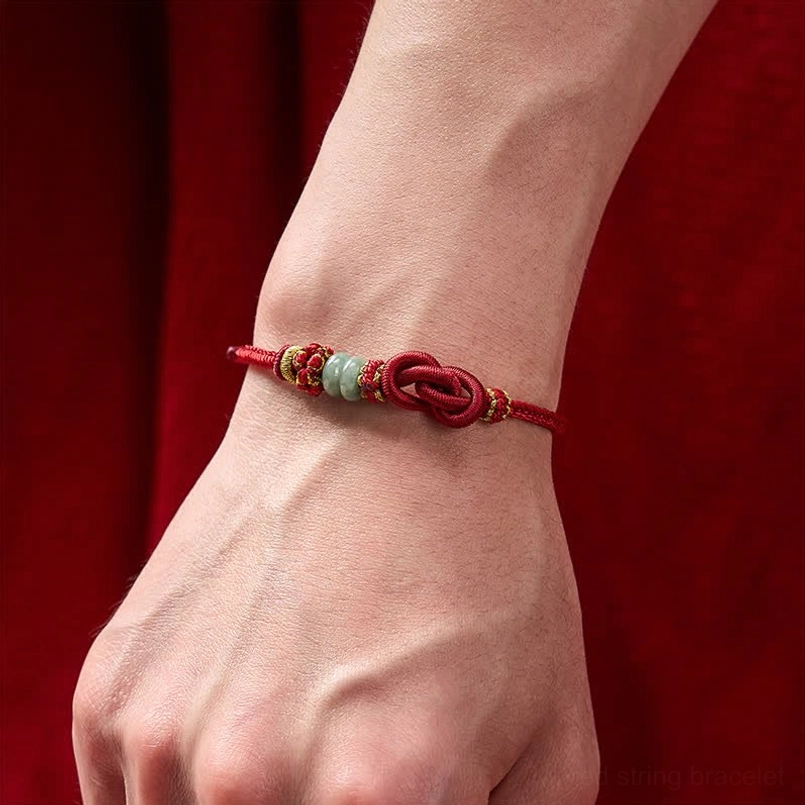 Hand-woven red cord jade bracelet with adjustable closure detail