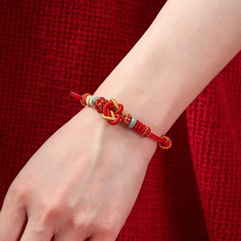 Red gold and jade woven bracelet worn on wrist showing natural fit and style