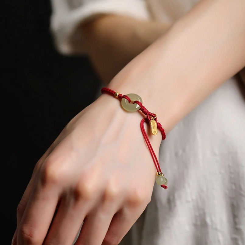 Lucky red string jade peace buckle bracelet worn on wrist lifestyle photo