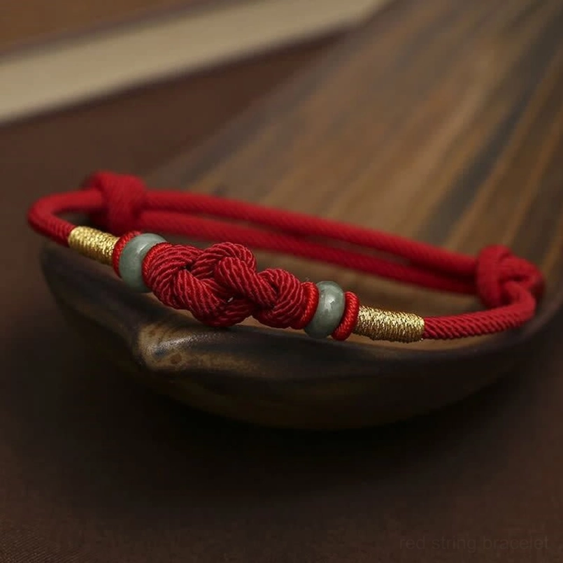 Red braided cord jade fortune knot bracelet with twisted design detail