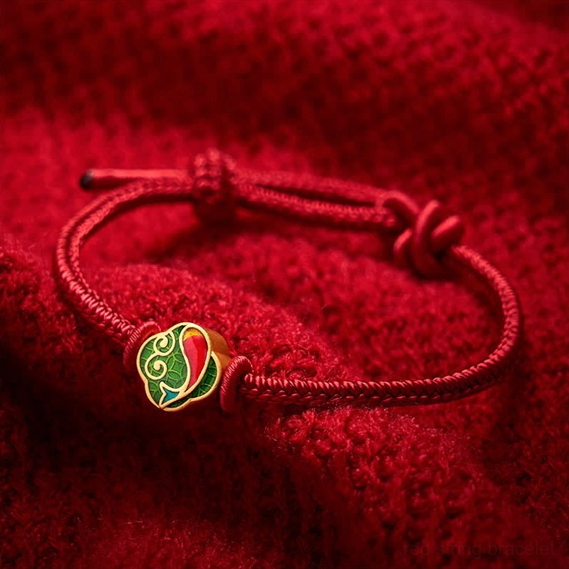 Handmade red string koi fish bracelet with double charm, adjustable sliding knot, flat lay view
