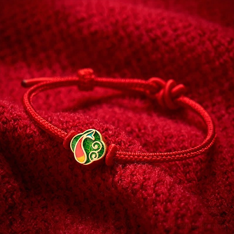 Red string protection bracelet featuring koi fish charm, dual adjustment knots on woven cord
