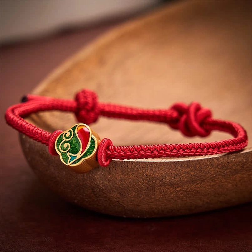Adjustable red string koi fish bracelet with dual sliding knots, wrist sizing demonstration
