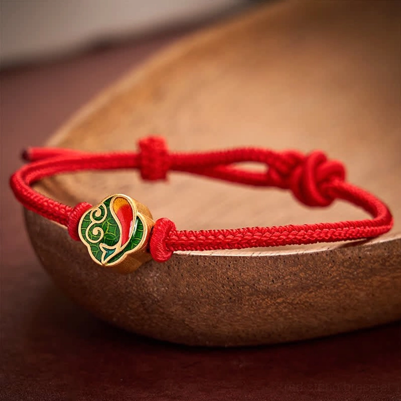 Handmade red braided cord bracelet with double koi fish charm, artisan crafted detail view