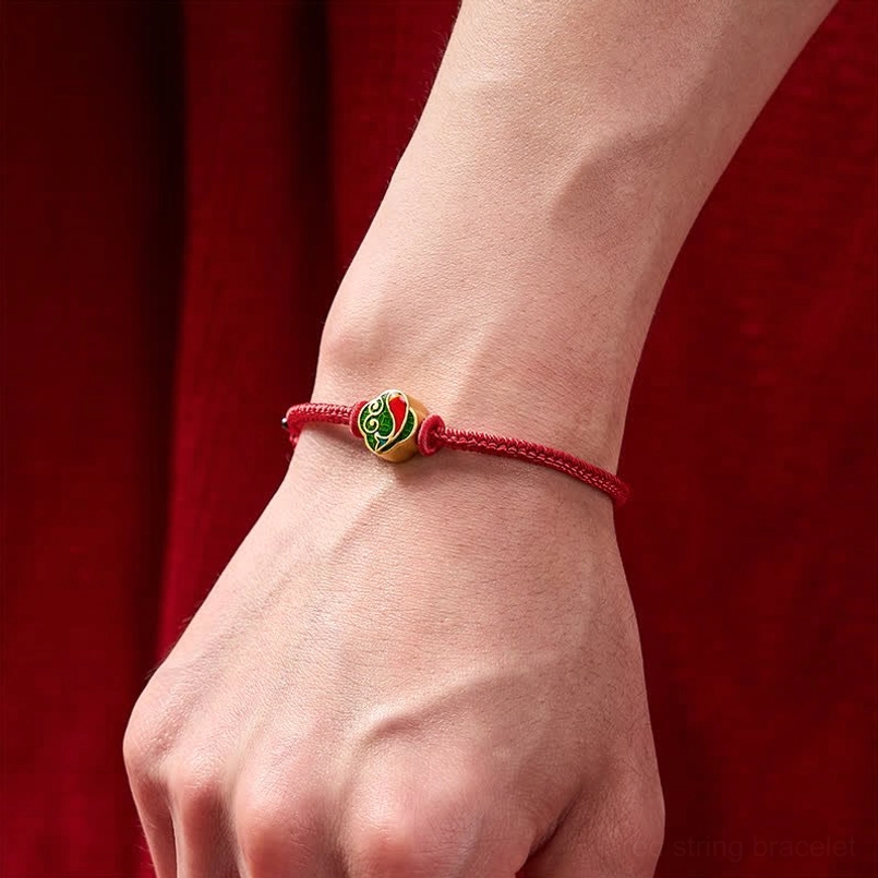 Red string protection bracelet worn on wrist, slim fit enamel koi fish charm visible
