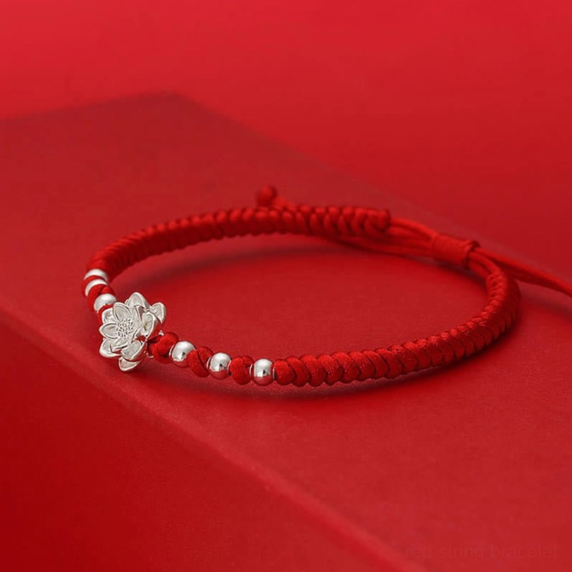 Red string lotus bracelet left side view braided red cord solid silver charm
