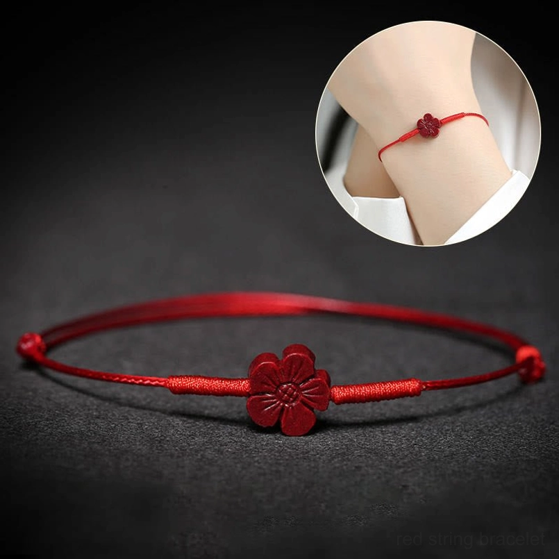 Red cord bracelet with lotus charm and adjustable sliding knots