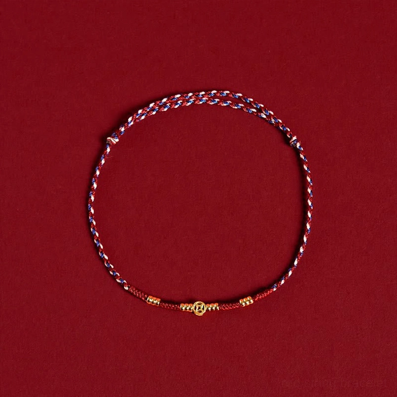 Handmade red and multi-color braided bracelet with copper coin charms, flat lay top-down view