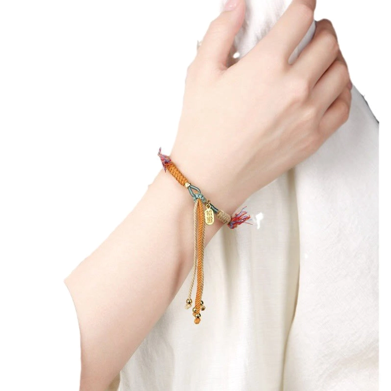 Close up of Tibetan luck red string bracelet worn on human wrist