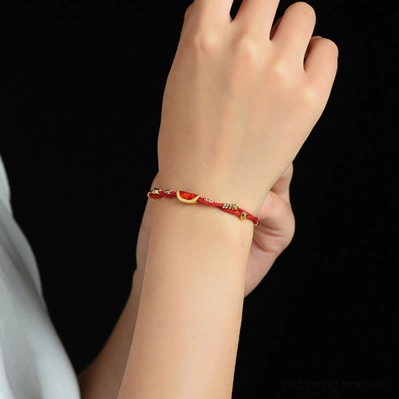 Lifestyle shot of cinnabar dumpling red string bracelet worn on human wrist