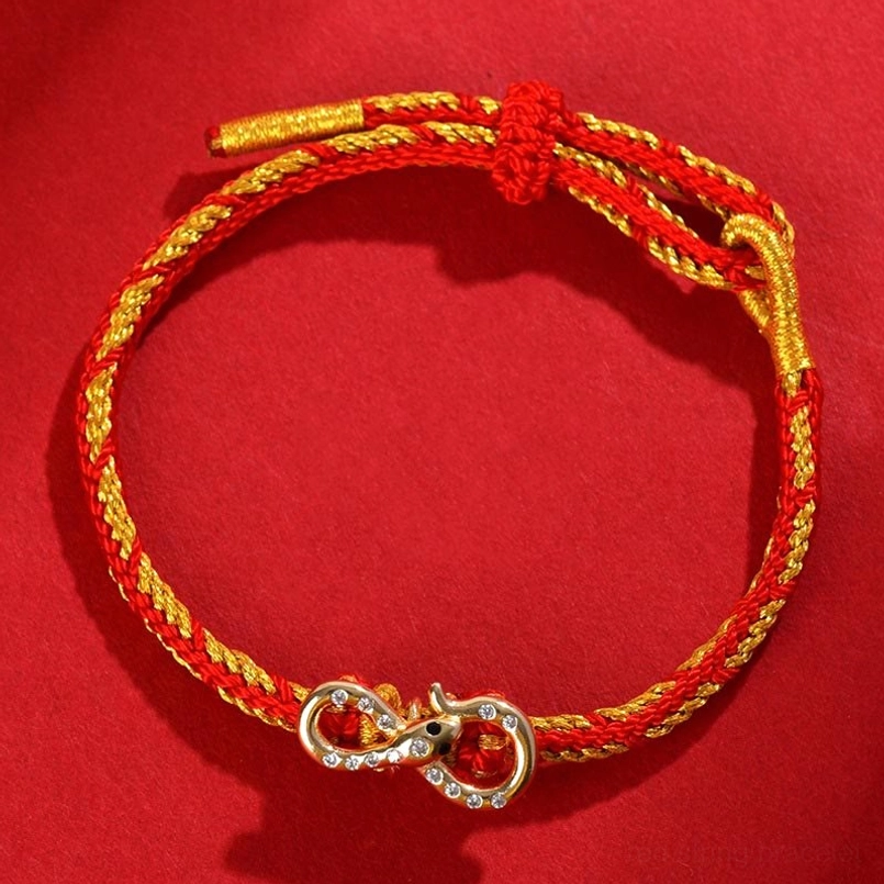 Red String Mobius Snake lucky bracelet flat lay showing two-tone woven cord and metal infinity clasp with adjustable toggle knot