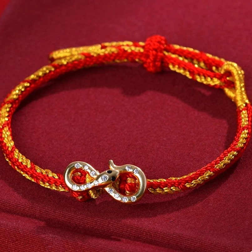 Red String Mobius Snake Year bracelet front top oblique view with red-gold twisted woven rope and large infinity charm with rhinestones