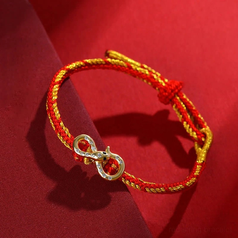 Red String Mobius Snake bracelet side oblique angle showing twisted red and gold cord with infinity charm and adjustable sliding knot