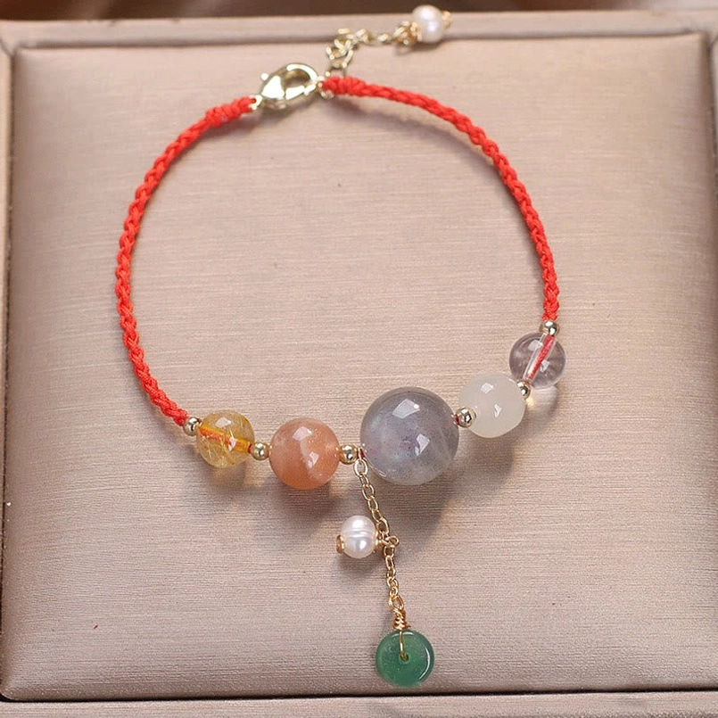 Red string moonstone peace buckle bracelet with mixed crystal beads and pearl accent in jewelry box