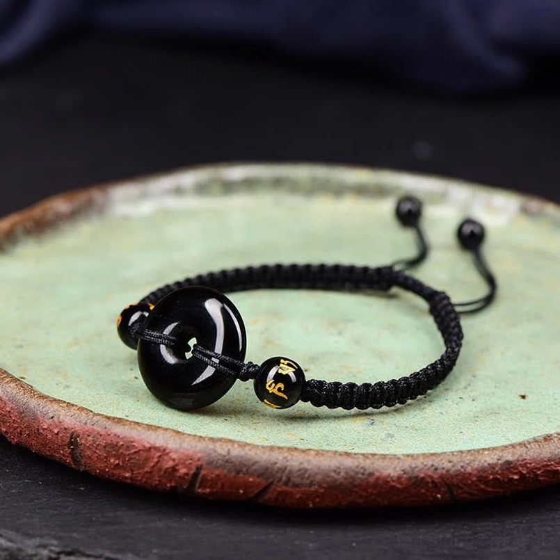 Black Obsidian Peace Buckle bracelet displaying adjustable pull knots detail