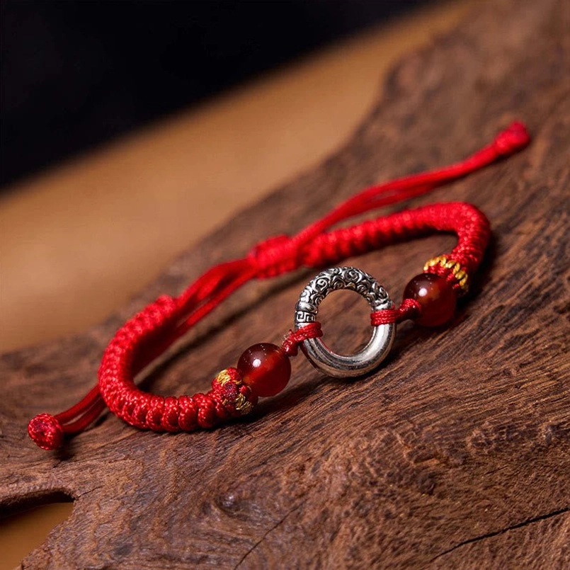 Red woven cord peace buckle bracelet with decorative agate beads detail side view