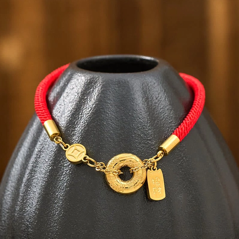 Red rope peace buckle bracelet flat lay showing matte woven cord and complete gold charm collection