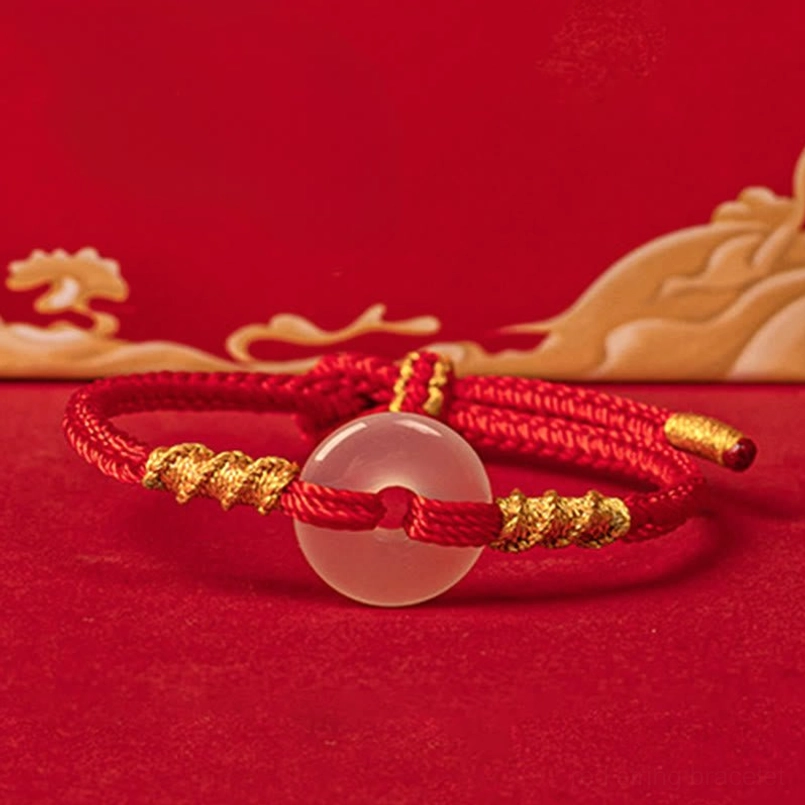 Red braided peace buckle bracelet with gold accents and white chalcedony, front oblique angle