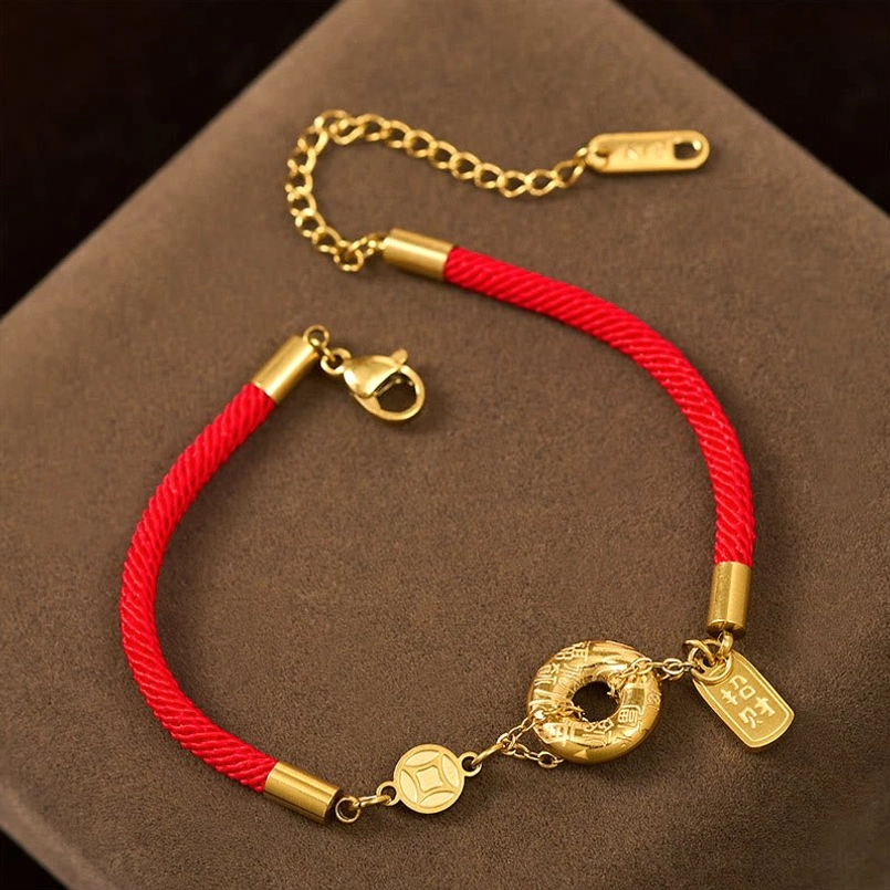 Red string bracelet side view showing lobster clasp and adjustable extension chain with metal tag
