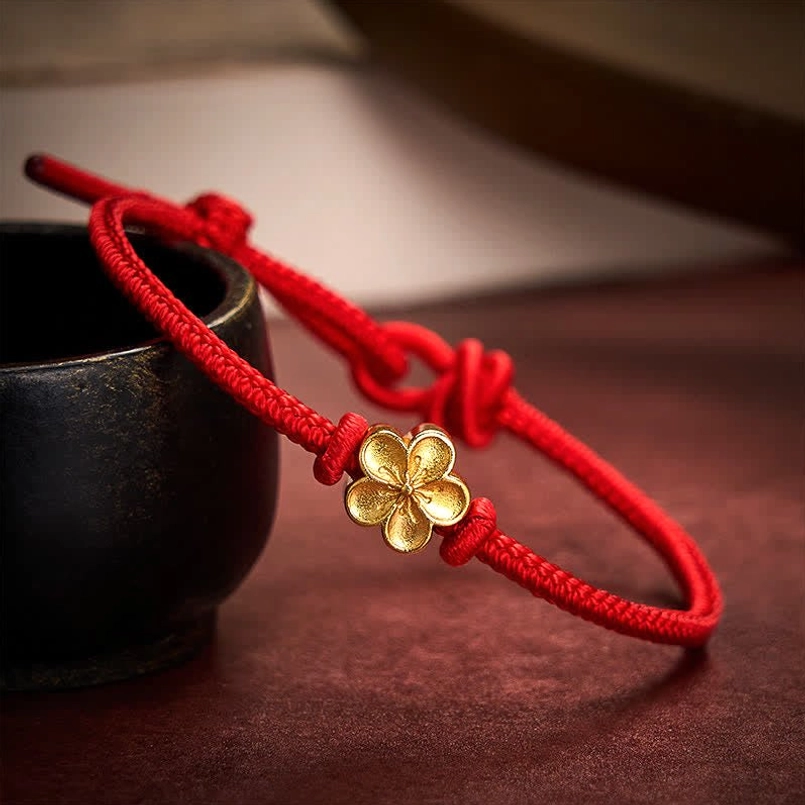 Handcrafted red string peach blossom bracelet with braided cord and gold flower charm