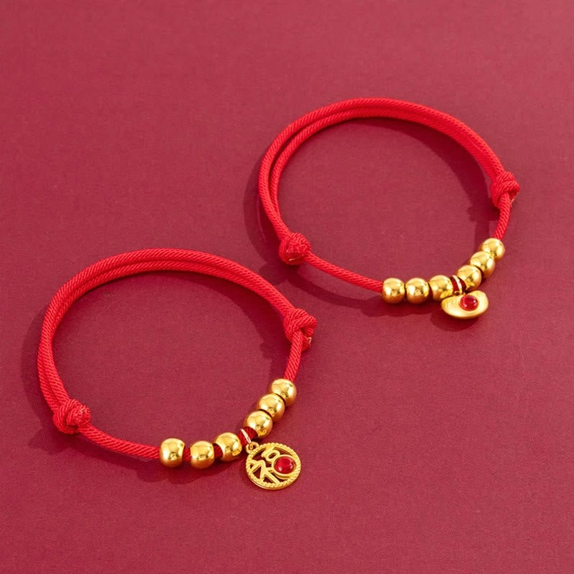 Red string pet collar with fu character charm, showing adjustable knot and protective design