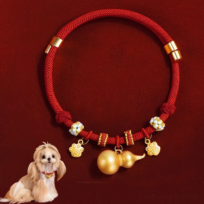 Handmade red woven rope pet collar with adjustable gold clasps and gourd paw pendants flat lay