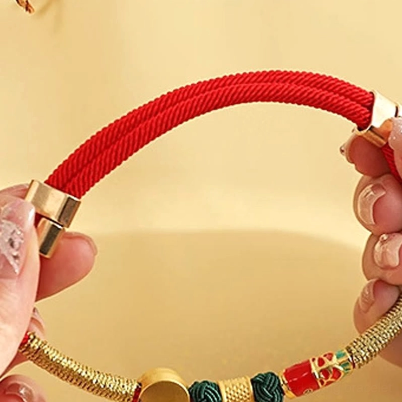 Hand holding red braided rope pet collar with metal adjustment buckle