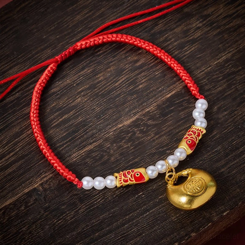 Adjustable red string pet collar with koi fish bead and fortune pendant on wooden surface