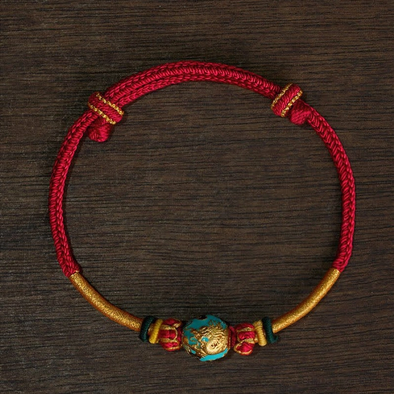 Red string phoenix bead bracelet symbolizing feminine energy and balance