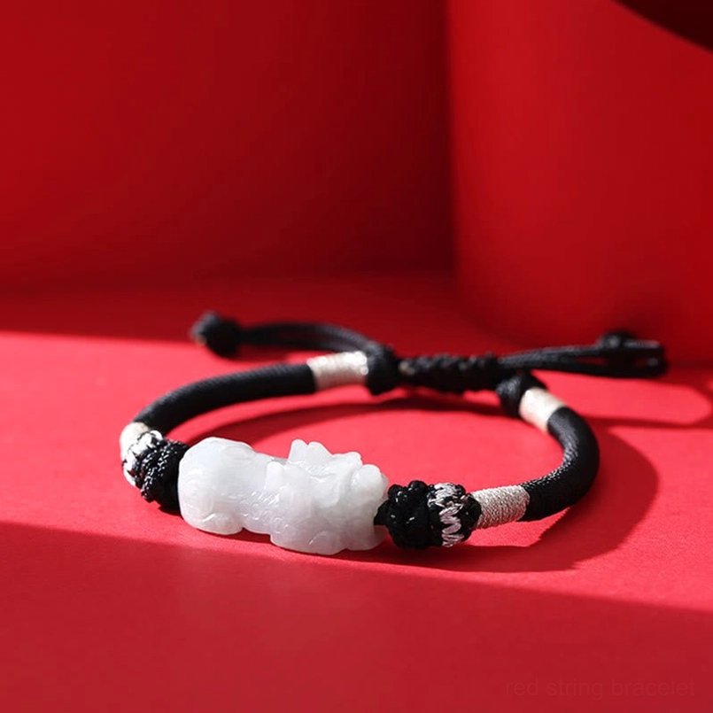 Handmade red string Pixiu bracelet - flat lay minimalist product shot