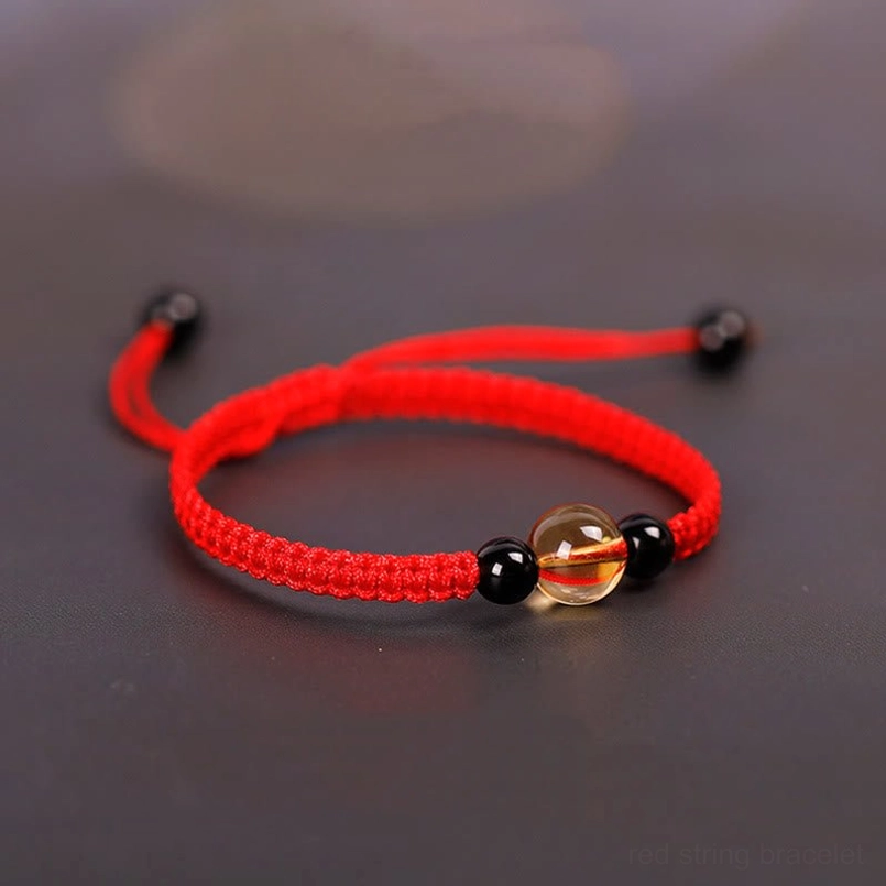 Red cord luck bracelet with citrine obsidian beads side profile view