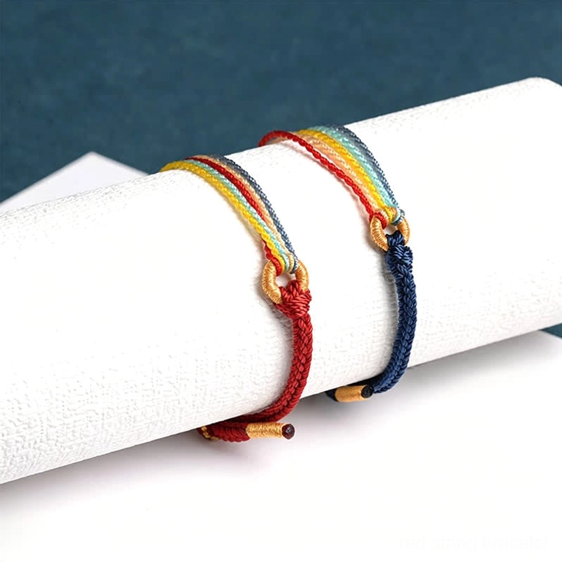 Handmade five color red string protection bracelets on display roll