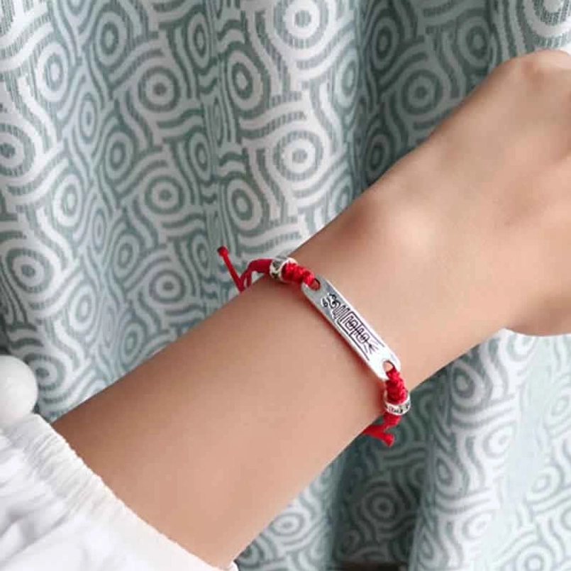 Red luck bracelet with reversed engraved silver plaque and protective swastika symbol