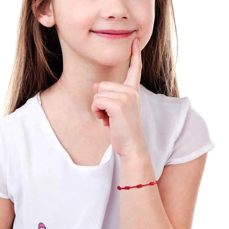 Single red string bracelet worn on female wrist daily wear demonstration