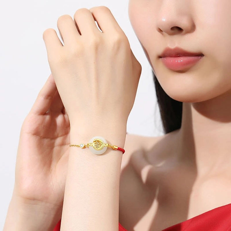 Red string Hetian jade peace buckle bracelet close up wearing demo on wrist