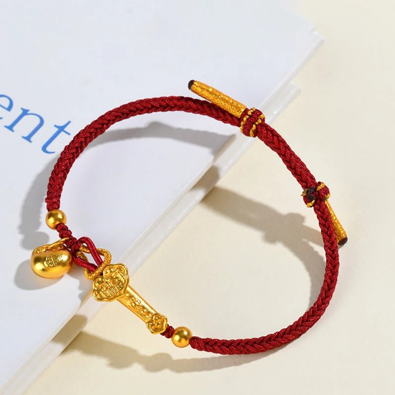 Handmade red string bracelet with Ruyi scepter and bell charm lifestyle view