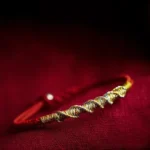 925 sterling silver red string bracelet close-up showing twisted gold-silver braid detail and metal clasp